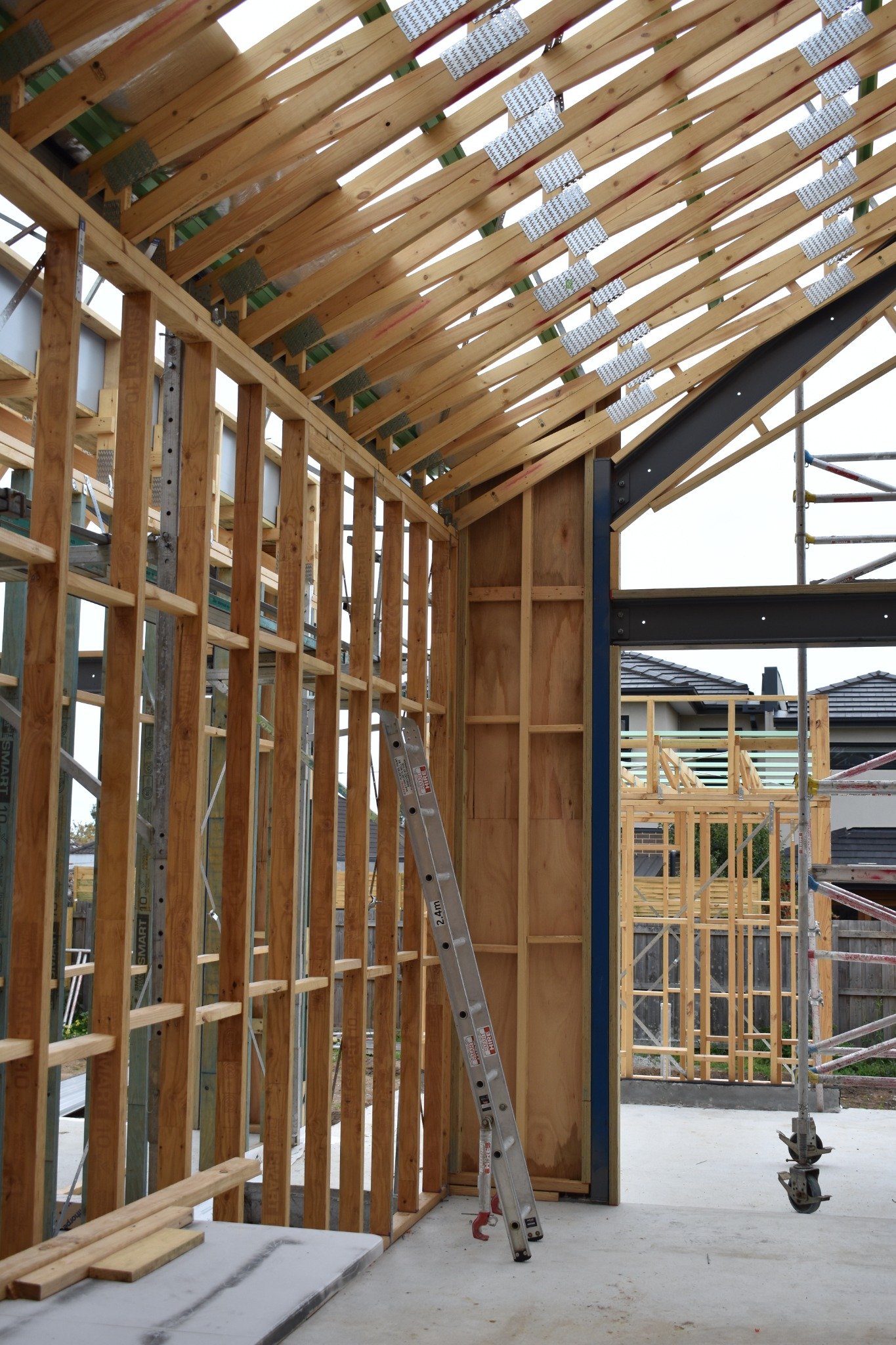 timber wall and roof framing with structural steel during construction.